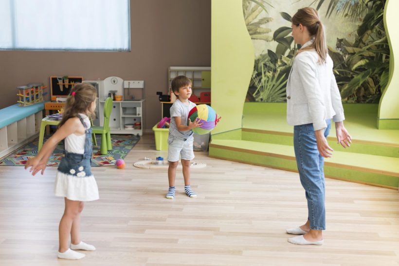 full-shot-teacher-kids-playing-with-ball